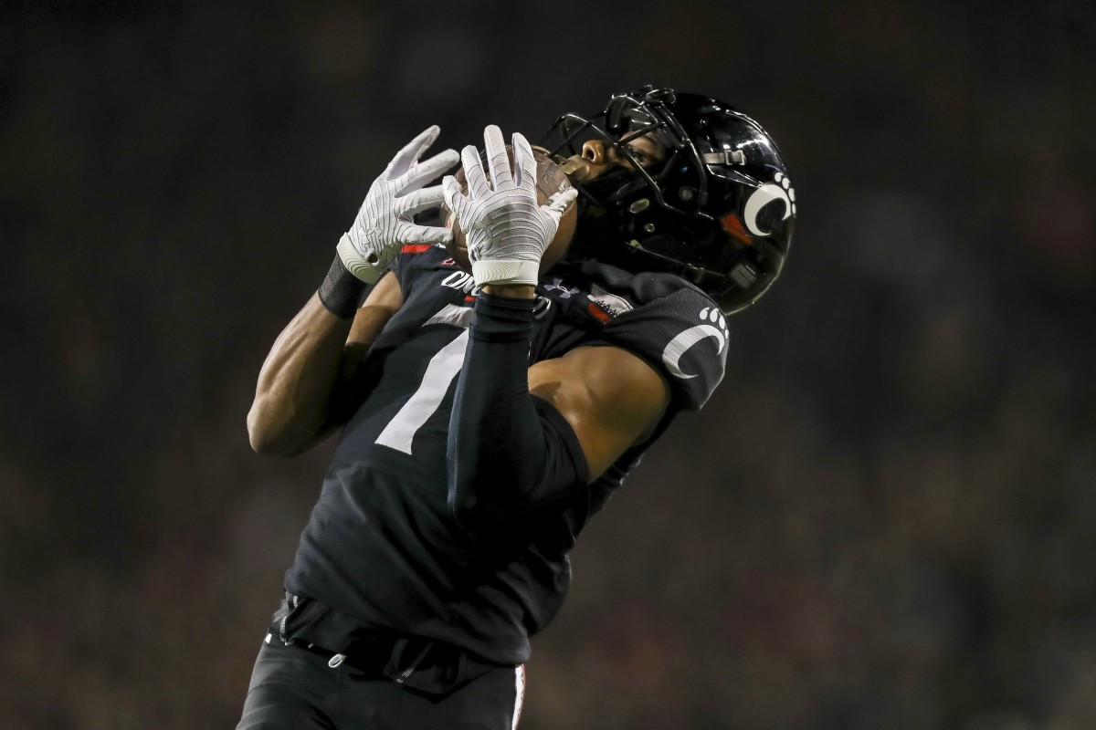 Oct 8, 2021; Cincinnati, Ohio, USA; Cincinnati Bearcats cornerback Coby Bryant (7) intercepts the ball against the Temple Owls in the second half at Nippert Stadium. Mandatory Credit: Katie Stratman-USA TODAY Sports